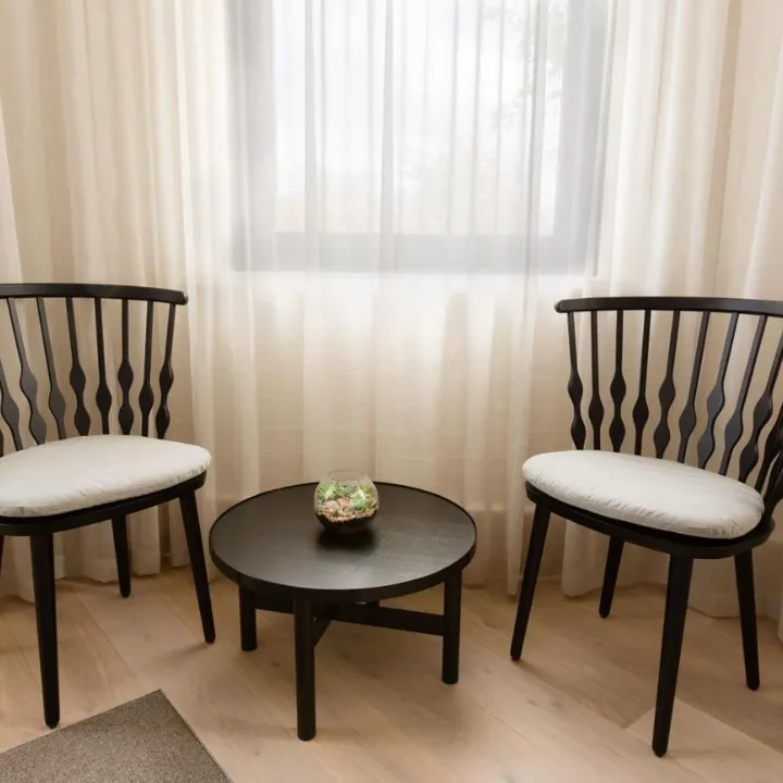 Sitting nook with two spindle chairs by the window
